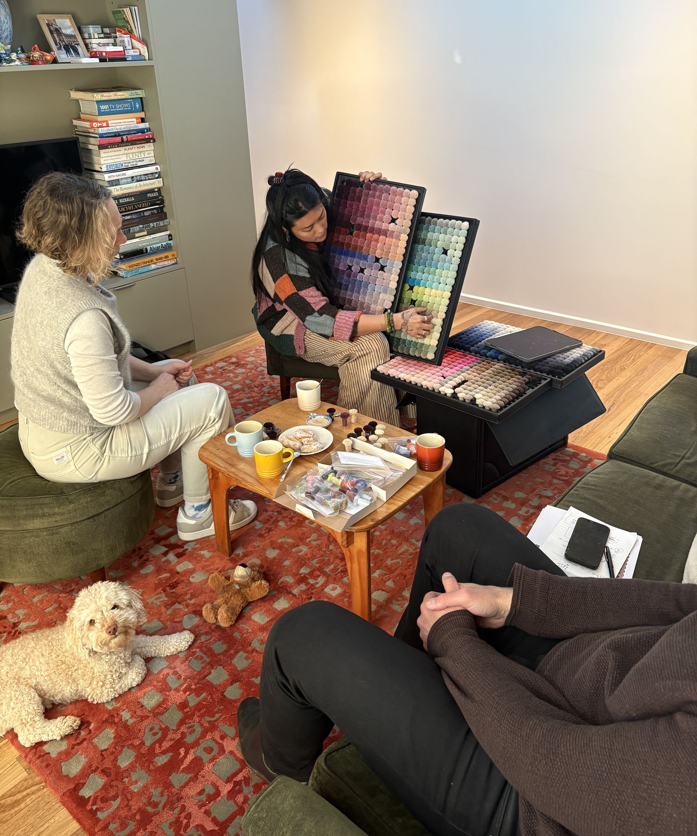 Carmellia showing wool colour trays to a client during a studio consultation