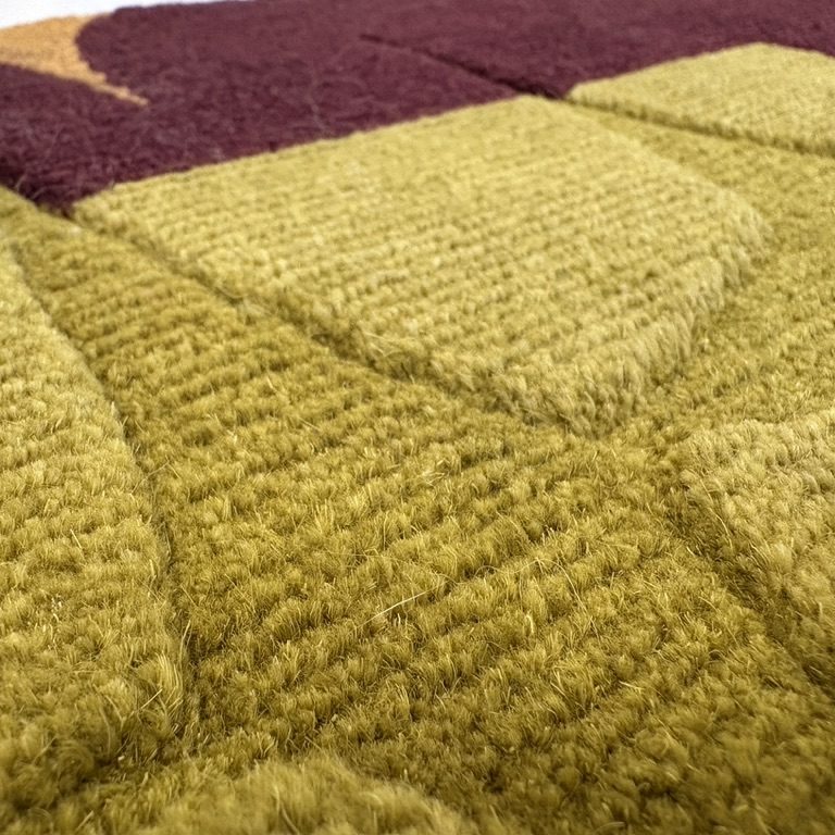 Close-up of a hand knotted rug showing dense knots