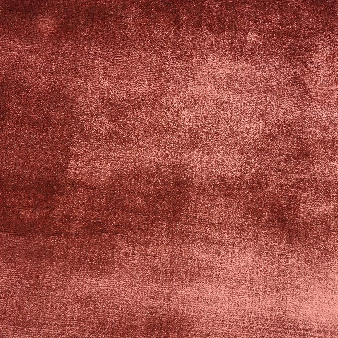 Close-up of a hand tufted rug with a carved, raised pile